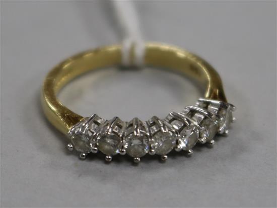 A modern 18ct gold and seven stone diamond set half hoop ring, size M.